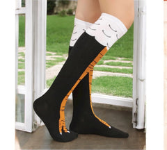 Hilarious chicken leg knee-high socks worn for fun, cozy comfort during Thanksgiving.