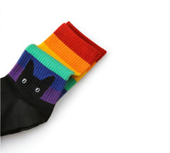 Close-up view of black Peeking Cat Rainbow Pride Socks with colorful rainbow stripes and adorable black cat design.
