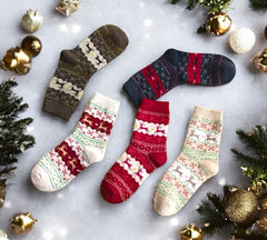 Set of five festive Christmas socks featuring reindeer and snowflake patterns in holiday colors like red, beige, white, and navy. Perfect for cozy winter days and holiday gifting.