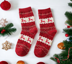 Bright red Christmas socks featuring playful white reindeer and intricate snowflake patterns, designed for warmth and seasonal charm.