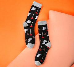 Cheeky and hilarious Funny Toilet Paper and Plunger Pattern Socks featuring poop emoji and plunger details, displayed on a vibrant orange backdrop.